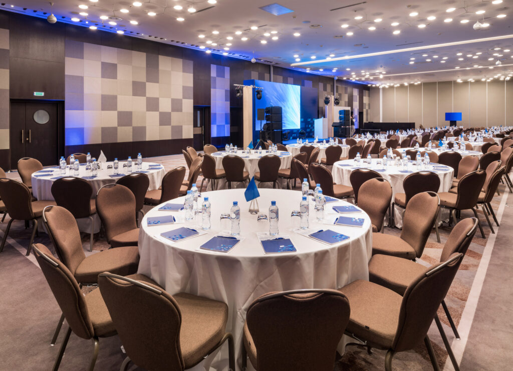 hotel conference room setup showing chairs, tables, and venue prepared
