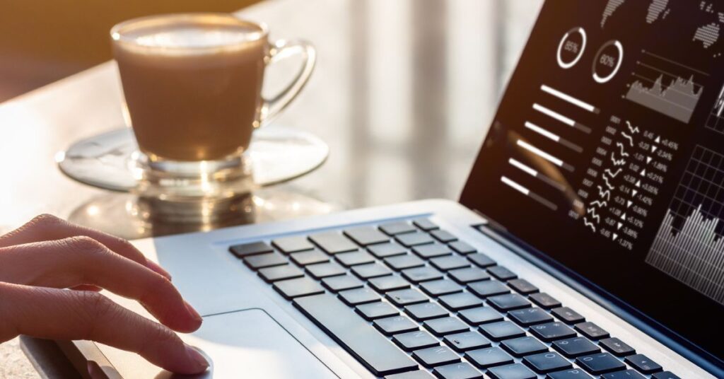 Person looking at charts and stats on laptop